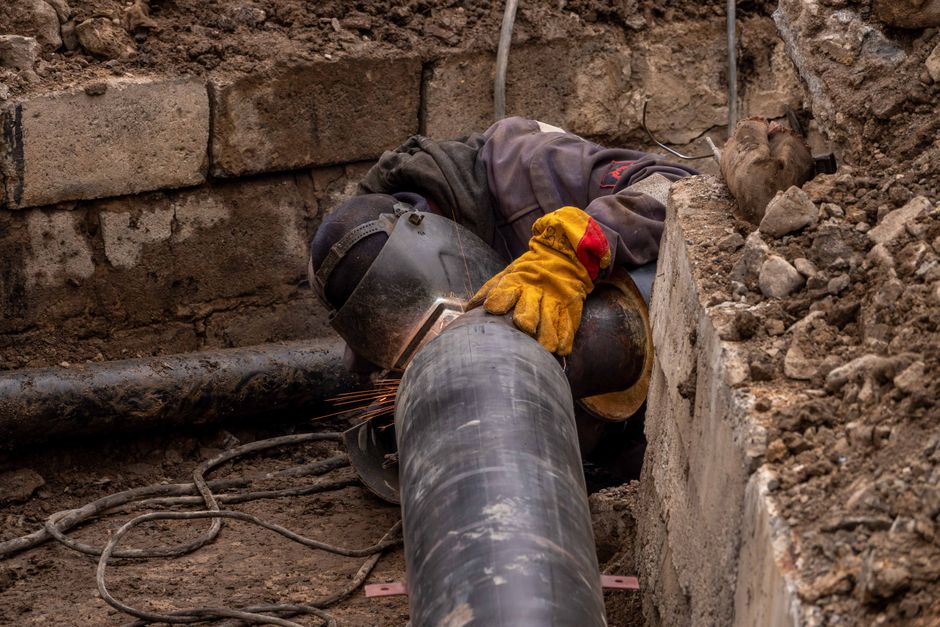 Close-up of drain pipe repair work in a suburban Redhill garden